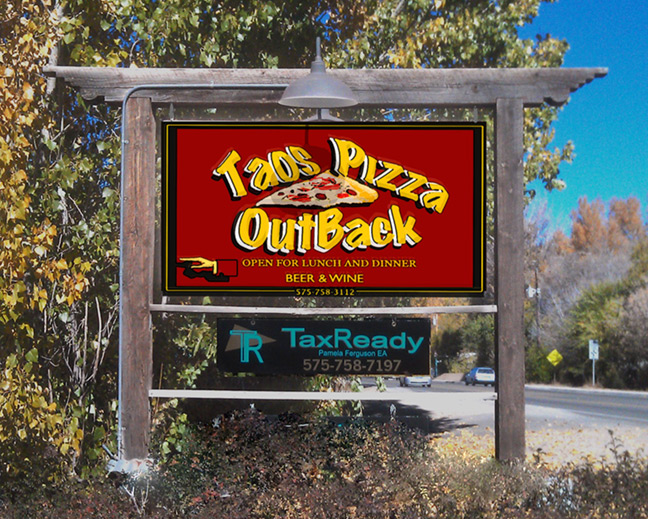 Roadside sign for Taos Pizza Out Back on Paseo Del Pueblo Norte